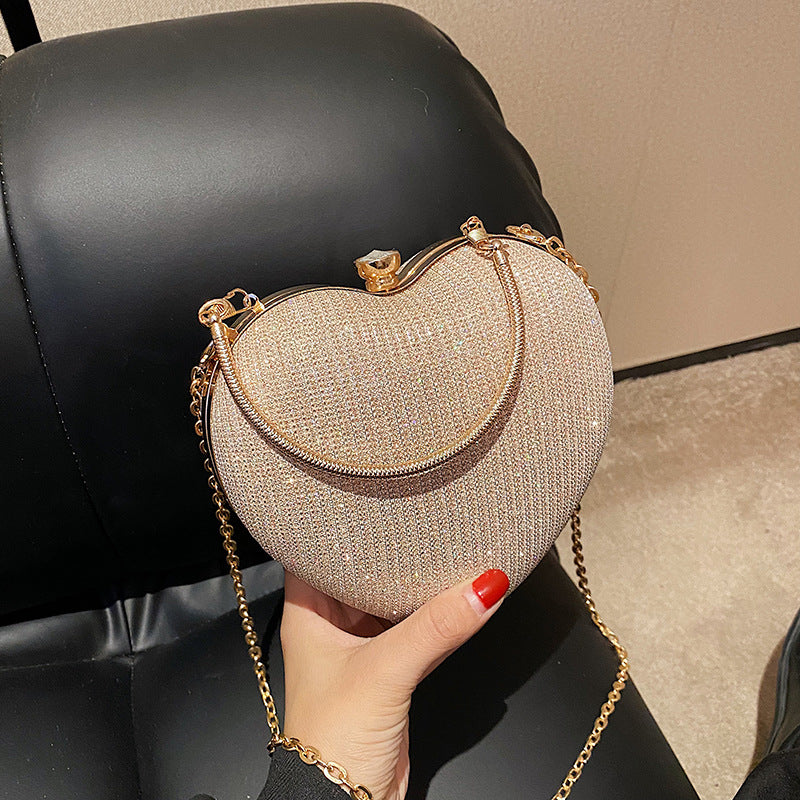 "Discover elegance with our Peach Heart-Shaped Hand Bag - a chic statement from Yuchimagic's fashion collection."