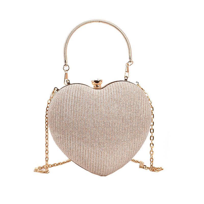 "Discover elegance with our Peach Heart-Shaped Hand Bag - a chic statement from Yuchimagic's fashion collection."