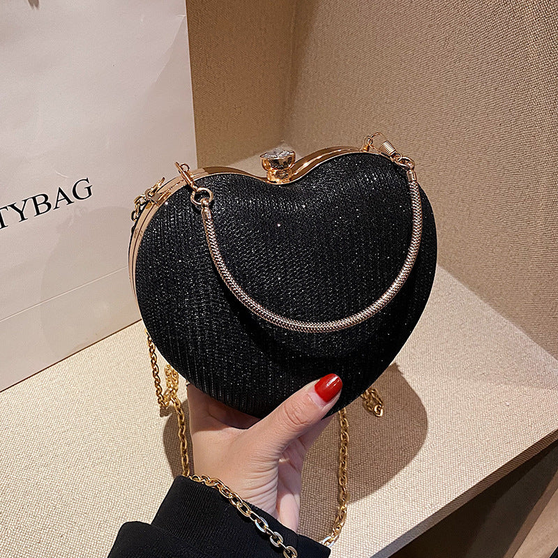 "Discover elegance with our Peach Heart-Shaped Hand Bag - a chic statement from Yuchimagic's fashion collection."