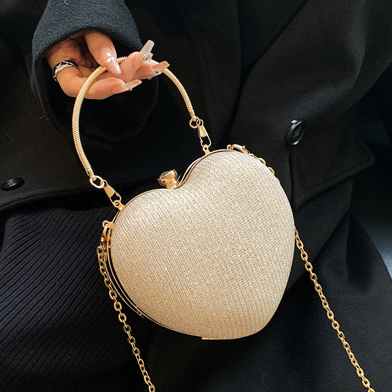 "Discover elegance with our Peach Heart-Shaped Hand Bag - a chic statement from Yuchimagic's fashion collection."
