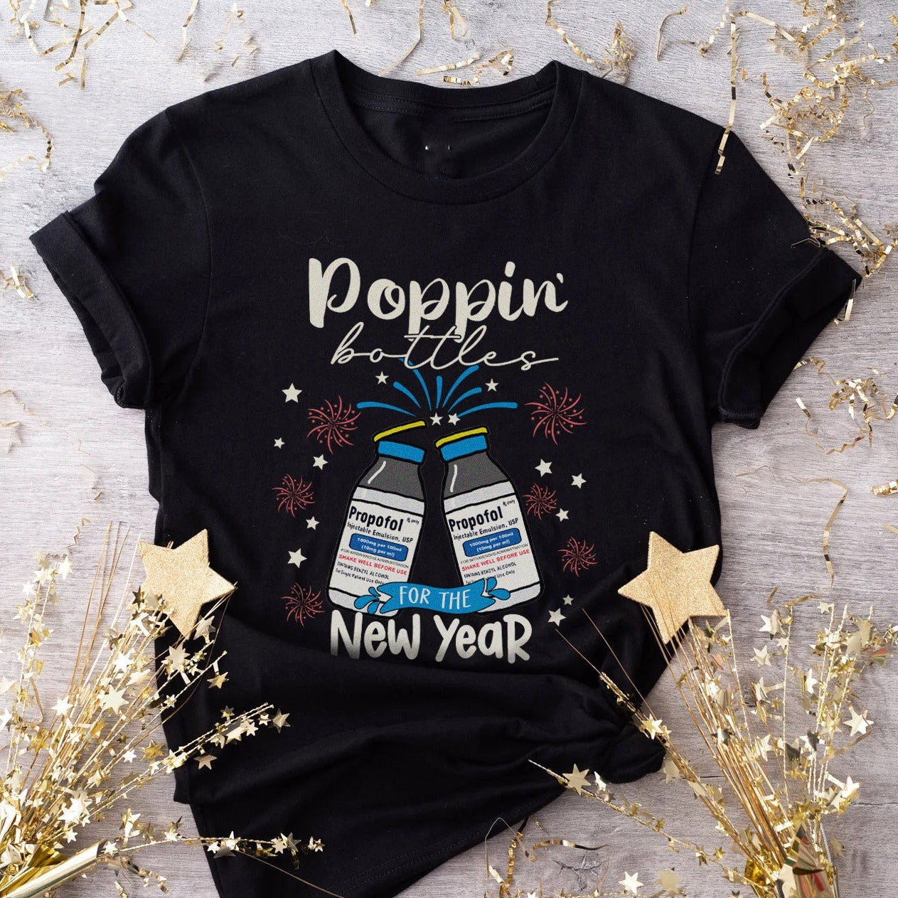 Celebrate in chic style with our Poppin Bottle New Year T-shirt in classic black. Cheers to fashion! image