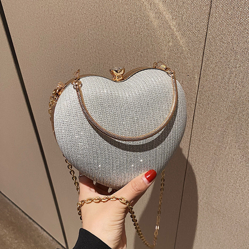 "Discover elegance with our Peach Heart-Shaped Hand Bag - a chic statement from Yuchimagic's fashion collection."