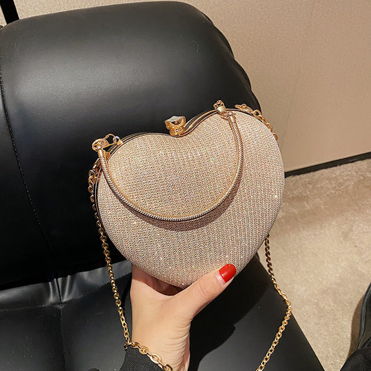 "Discover elegance with our Peach Heart-Shaped Hand Bag - a chic statement from Yuchimagic's fashion collection."